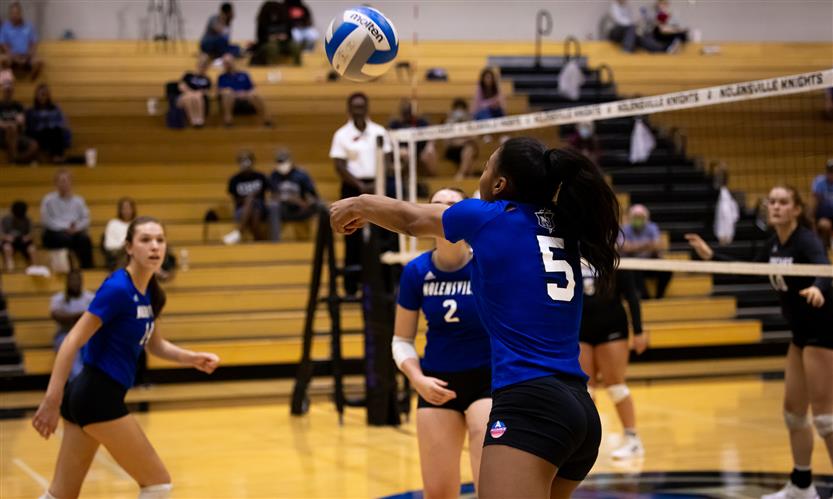 High school students play volleyball